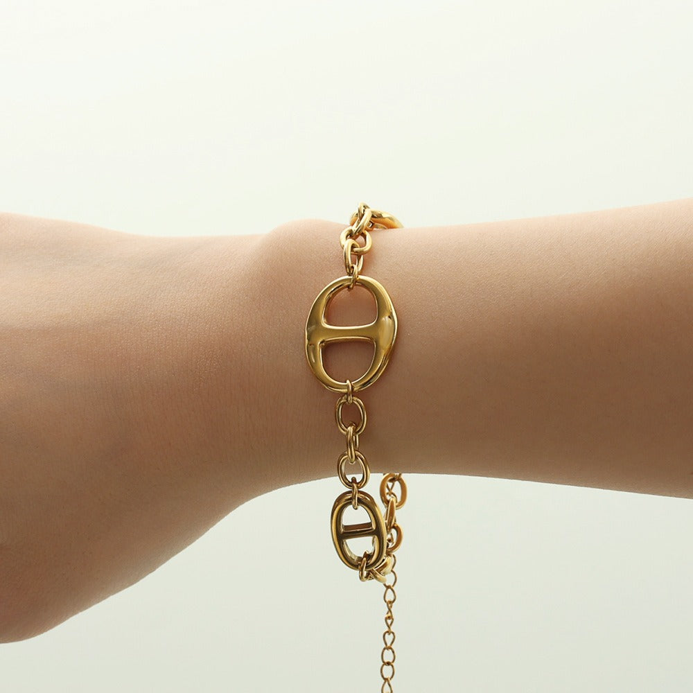 18K gold geometric-shaped necklace, bracelet, and earrings set.